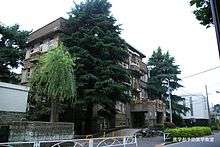 Old building with trees in front