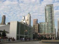 Building viewed from across the street on an angle. A skyline of other buildings are in the background.