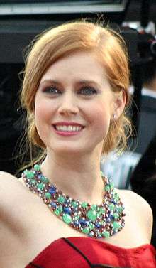 A photograph of Amy Adams looking towards the camera