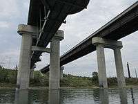 Anthony Henday Drive bridges over the North Saskatchewan River in southwest Edmonton, Alberta. The eastbound bridge includes a pedestrian walkway underneath the bridge.