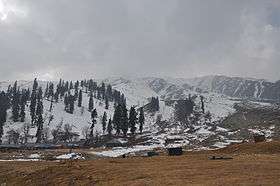 A large, snow-clad mountain ridge