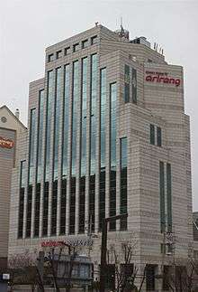 Large, gray, glass-fronted building