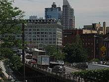 A congested elevated freeway passing through an area of urban high rise buildings