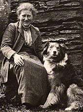 Photograph of an older woman and a dog, dated 1913