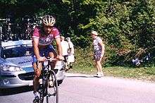 A cyclist wearing a purple jersey.