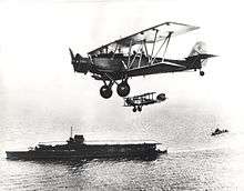 Blackburn Sharks in flight, HMS Courageous in background