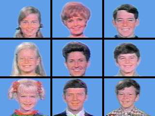 A 3 x 3 grid of squares with face shots of all nine starring characters of the television series: three blond girls in the left three squares, three brown-haired boys in the right three squares, and the middle three squares feature a blond motherly woman, a dark-haired woman, and a brown-haired man; all the faces are on blue backgrounds.