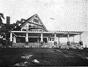 Pergola attached to a large Tudor building