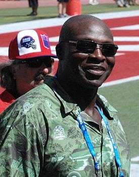 A man wearing glasses in a green shirt.