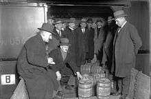 men standing around looking at barrels