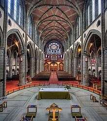 The west gallery houses a four-manual pipe organ built around a large rose window