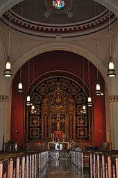 A view down the nave of a church with the altar visible