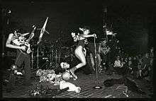 Colette Miller performing on stage with punk band GWAR in Richmond, Virginia