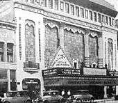 Tall building with a marquee featuring production of "Dance of Life".