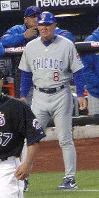 Man wearing gray uniform on a baseball infield