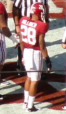 American football player in a red jersey on the field.