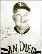 A middle-aged man wearing a light-colored San Diego baseball uniform; the photograph bears a signature saying "Don Zimmer"