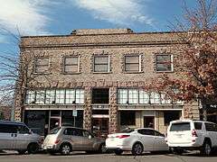 Photograph of a two-story, stone commercial building