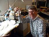 Crew member Vernon Kramer with a sample of water extracted from solid rock.