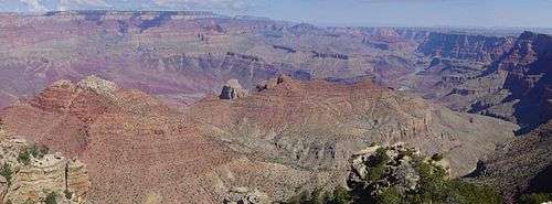 Wide canyon with exposed red- and tan-colored rock