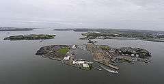 Aerial view with Naval Base to west (right), industrial site to east (left) & dockyard (centre)