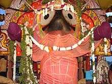 image of a temple idol decorated with flowers and fabric