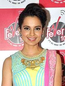 Kangana Ranaut is smiling at the camera