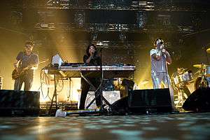 Colour photograph of LCD Soundsystem performing live in 2010.