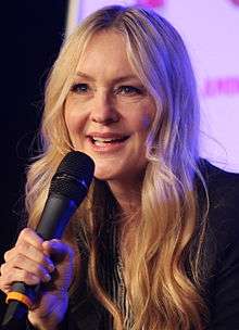 Image of actress Linda Larkin, speaking voice of Princess Jasmine, addressing an unseen audience at a convention.