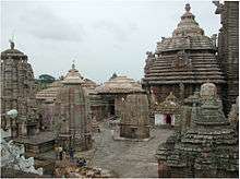 Image of a conical temple tower with smaller shrines around it