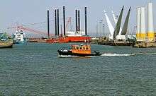 Image of harbour with windfarm construction