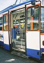 Entry door of a high-floor tram. Note the stair steps just inside the door.