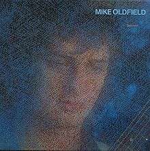 A blue mottled image of Oldfield's face and a portion of a guitar neck. The words Mike Oldfield Discovery are to the top right of the image.