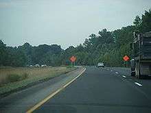 A four lane freeway running through a wooded area