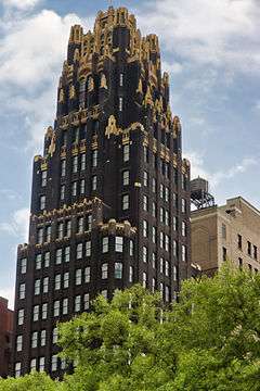 Older skyscraper, with trees in front