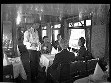 Waiter serving party of four in 1947