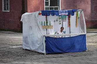 A North Korean vendor on a makeshift market stand selling goods.