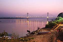 Long bridge, with its lights reflected in the water