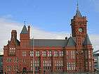 Victorian red brick building with clock tower to the right