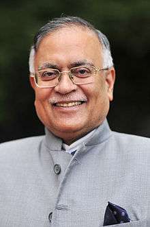 Head and shoulders portrait of Pradeep Kumar Kapur wearing Indian dress with pocket square.