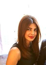 A photograph of Priyanka Chopra looking forward, smiling and posing for the camera