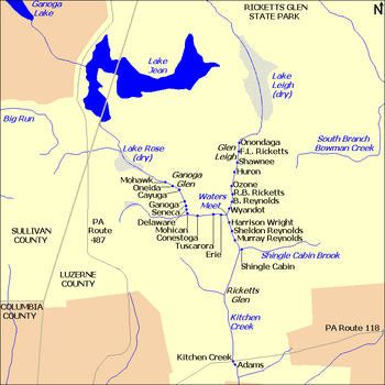 A map showing Kitchen Creek flowing southeast from Ganoga Lake, through Lake Jean, and then through the dry bed of Lake Rose into Ganoga Glen with ten waterfalls. A second branch of the creek flows south through the dry bed of Lake Leigh, then through Glen Leigh and its eight waterfalls. These branches meet at Waters Meet and the creek flows south through Ricketts Glen and its six waterfalls. The South Branch Bowman Creek is east of Lake Leigh and Big Run is west of Lake Rose. Pennsylvania Route 487 runs north-south at left, and Pennsylvania Route 118 runs east-west at the bottom of the map. County borders are also shown.