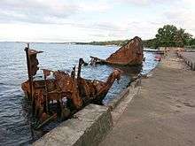 Sir Thomas Koh Chan's shipwreck (MV Yandina) at the market's boat ramp, in March 2016. One of the vessels of which market vendors have asked the immediate removal.