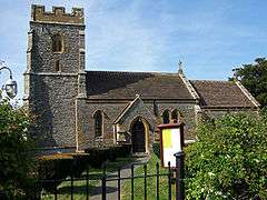 Stone building with square tower.