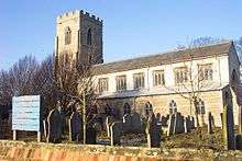 A stone church seen from the southeast, with a long south aisle and clerestory and a battlemented tower