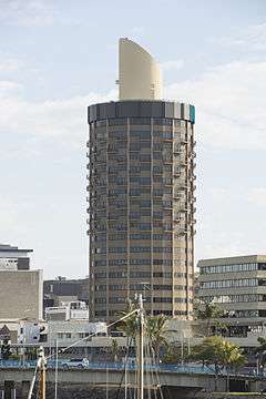 A cylindrical building against a night sky