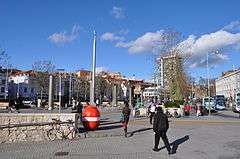 The Centre, Bristol viewed from the Quay Head. L-R: Hippodrome, WW1 German mine (once used to collect money for services charities), Colston Hall , Colston Tower, buses on Broad Quay. Fountains of Centre Promenade in foreground.