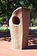 Granite sculpture consisting of a rough-hewn rectangular pillar enclosing a more polished rectangular internal structure