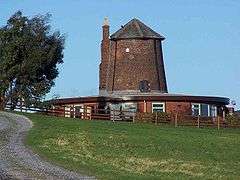 A traditional English windmill that has been converted into a dwelling