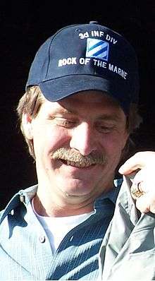 Jeff Foxworthy accepting a jacket from 3rd Infantry Division Commander Army Maj. Gen. William G. Webster.